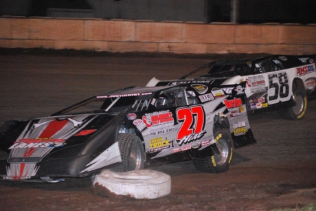 Justin Hirt (27) clipped an infield tire as A.J. Diemel (58) made his winning move. (Shawn Fredenberg)