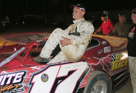 Winner Tim Allen climbs from his car. (Thomas Pope)