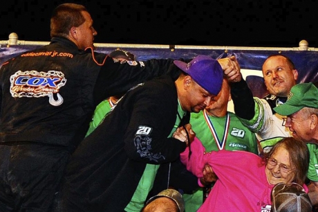 Eddie Carrier Jr. (left) stretches to congratulate World 100 winner Jimmy Owens. (thesportswire.net)