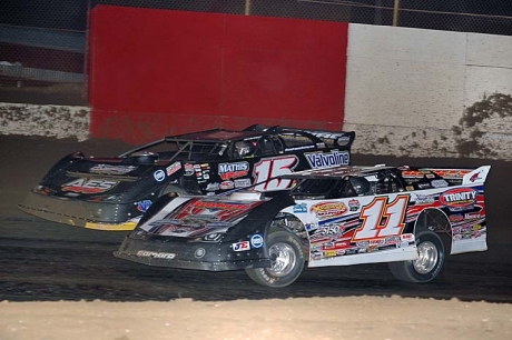 Steve Francis (15) moves around Austin Hubbard in the final corner at East Bay. (neilmiller.com)