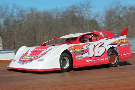 Corey Posey tunes up before his Winchester victory. (Carla Gault)