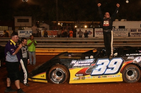 Steve Blackburn climbs atop his car to celebrate his victory. (A&M Photography)