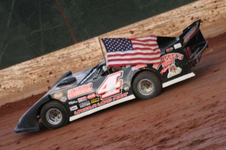 Victor Lee carries the flag during pre-race ceremonies. (Derrick Strader)