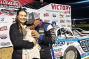 Devin Moran, with wife Lakia, kisses their daughter Poppy Jane after March 28's Lucas Oil Late Model Dirt Series victory at Brownstown (Ind.) Speedway. (DirtonDirt)