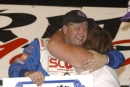 Chub Frank's wife Mary hugs him in victory lane Sept. 11, 2004, on Eldora Speedway's victory stage after his World 100 victory. (Brian McLeod)